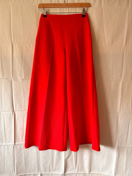 front view of 1960s/70s red textured high waisted flares