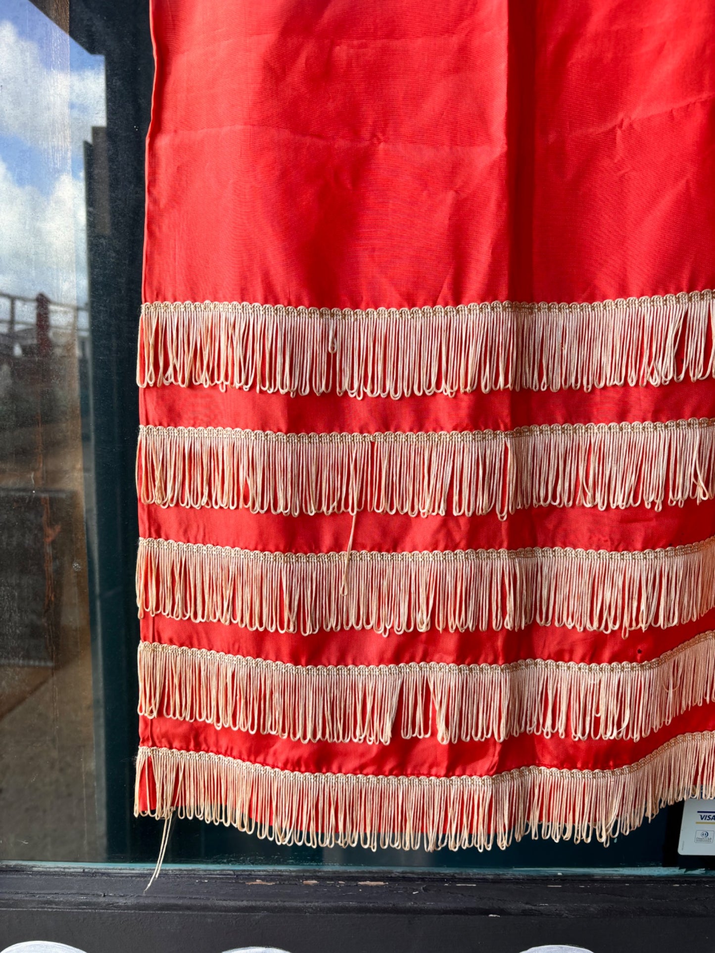 Red fabric with white fringe 