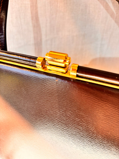 Close-up of a clutch bag with gold latch clasp