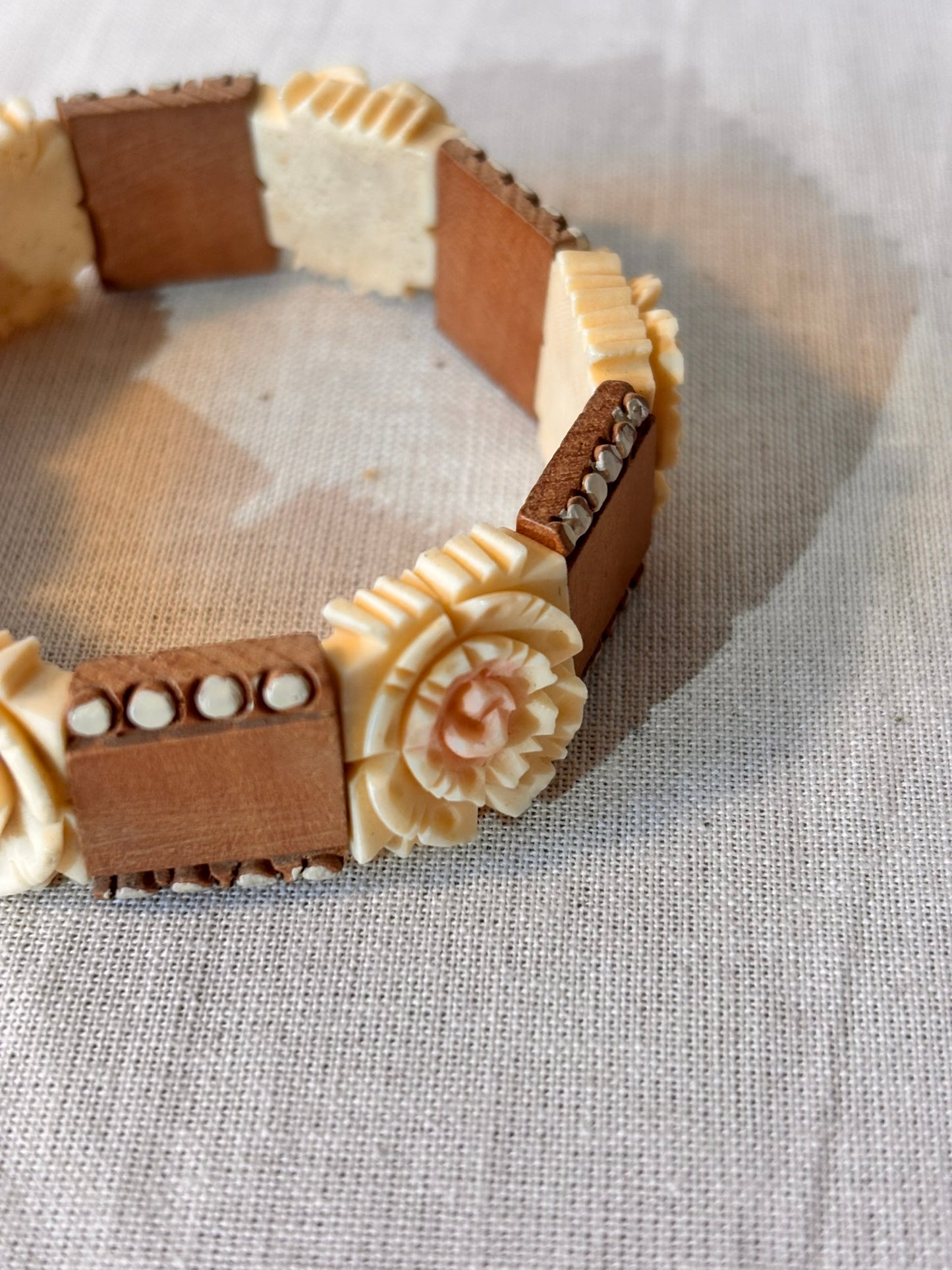 Close up of Vintage Wooden Bracelet with Carved Rose Detail